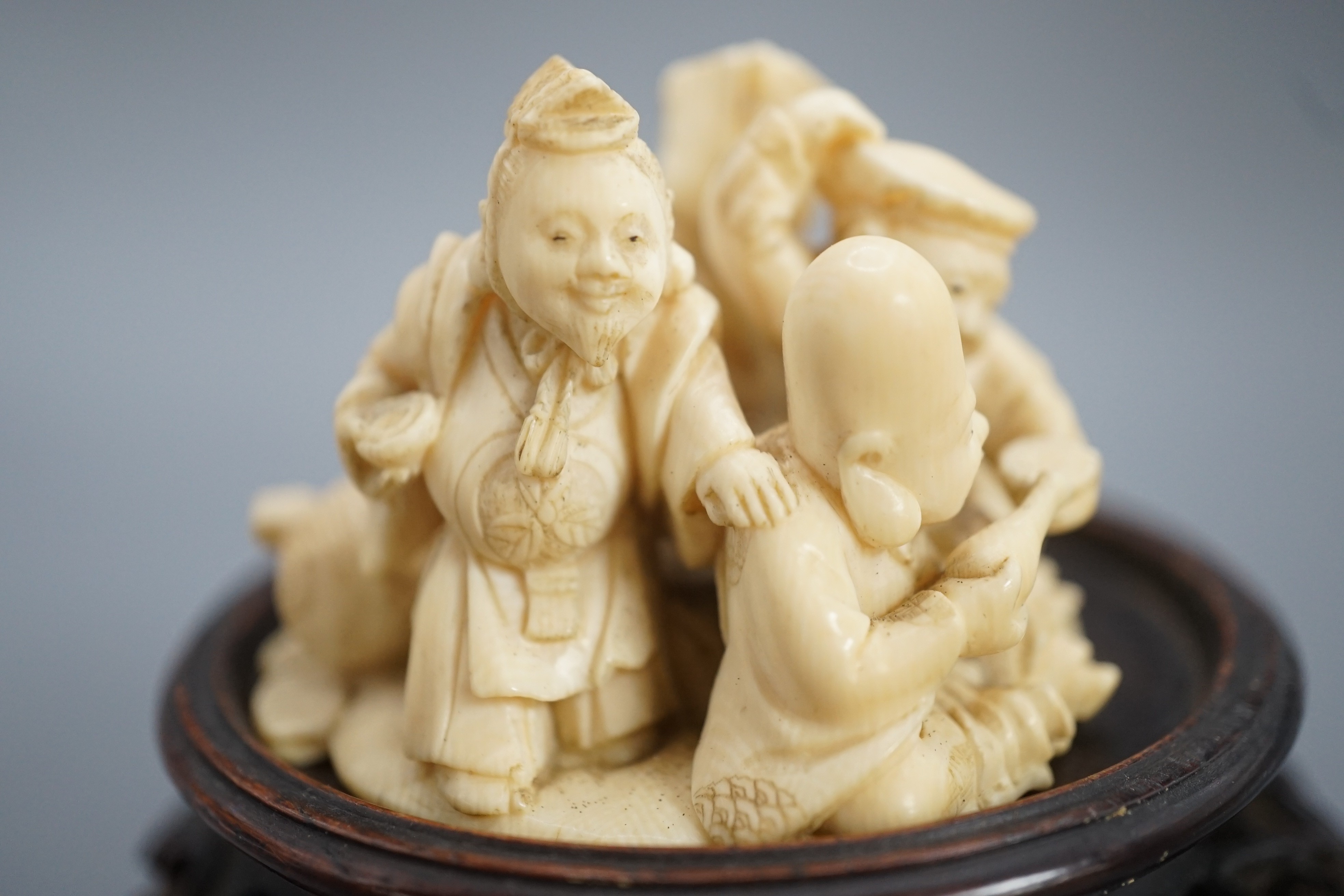 A Japanese ivory okimono of four of the Gods of Happiness, signed Gyokuzan, early 20th century, 6cm